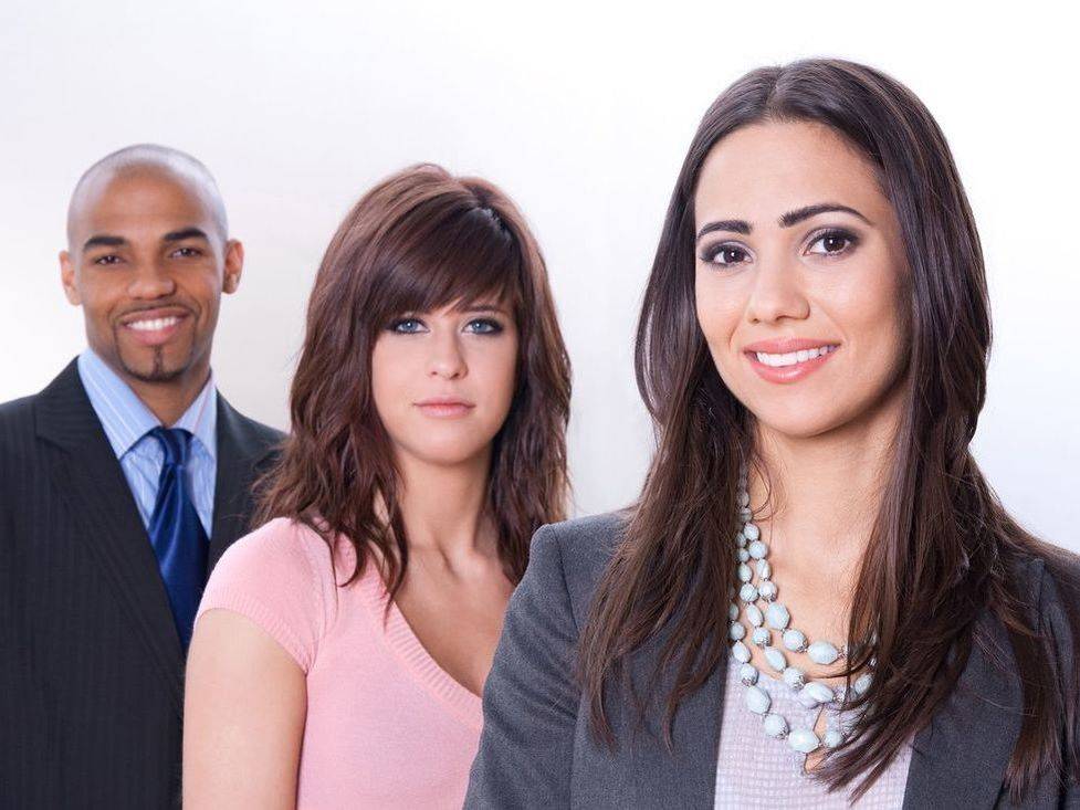 Three business professionals smiling for photo.