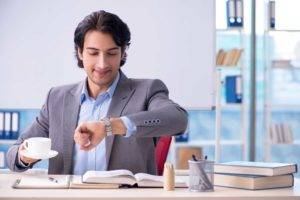 Professional Certification, Man in suit checking his watch.